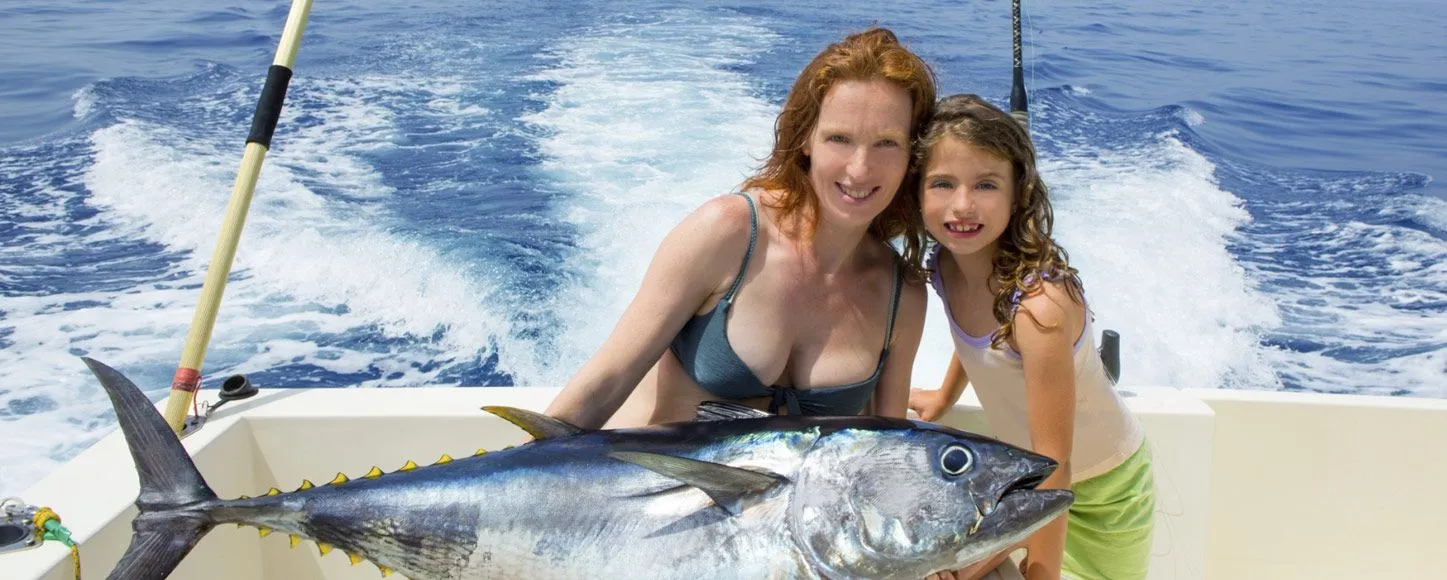 Mother and daughter with a fish they caught