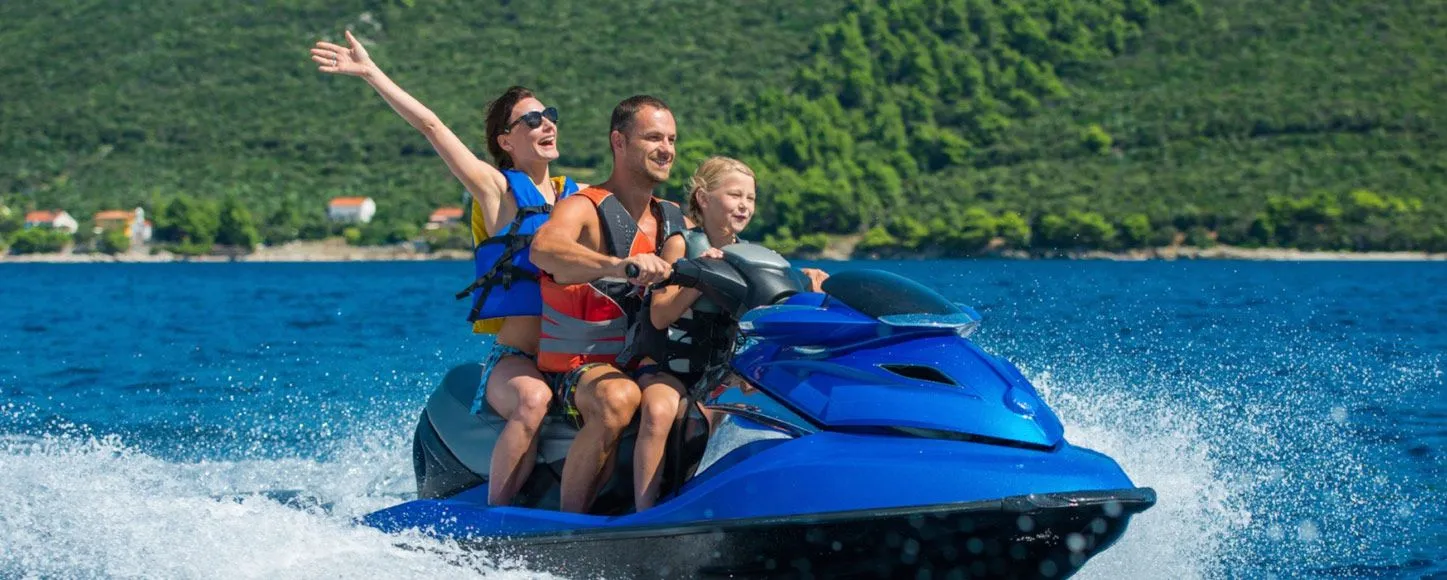 Farther, mother and daughter on a jet ski