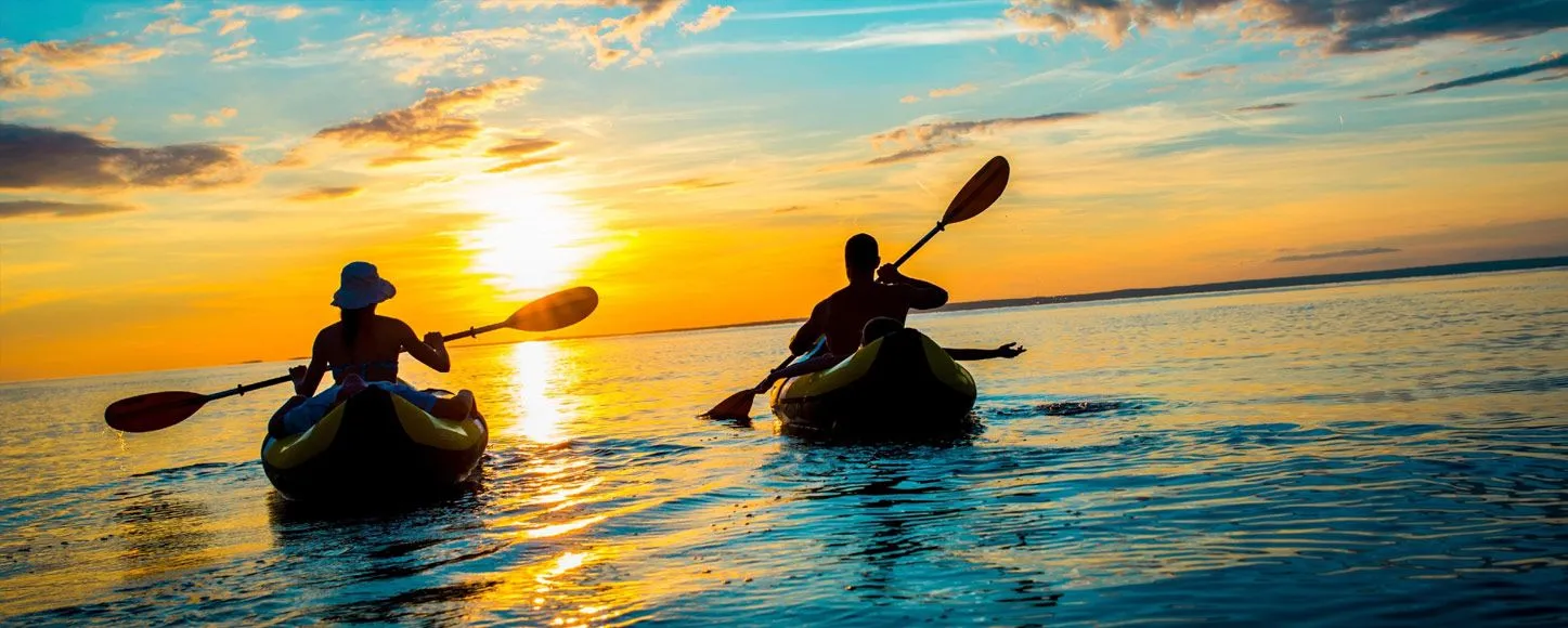 Two people Kayaking at sunset